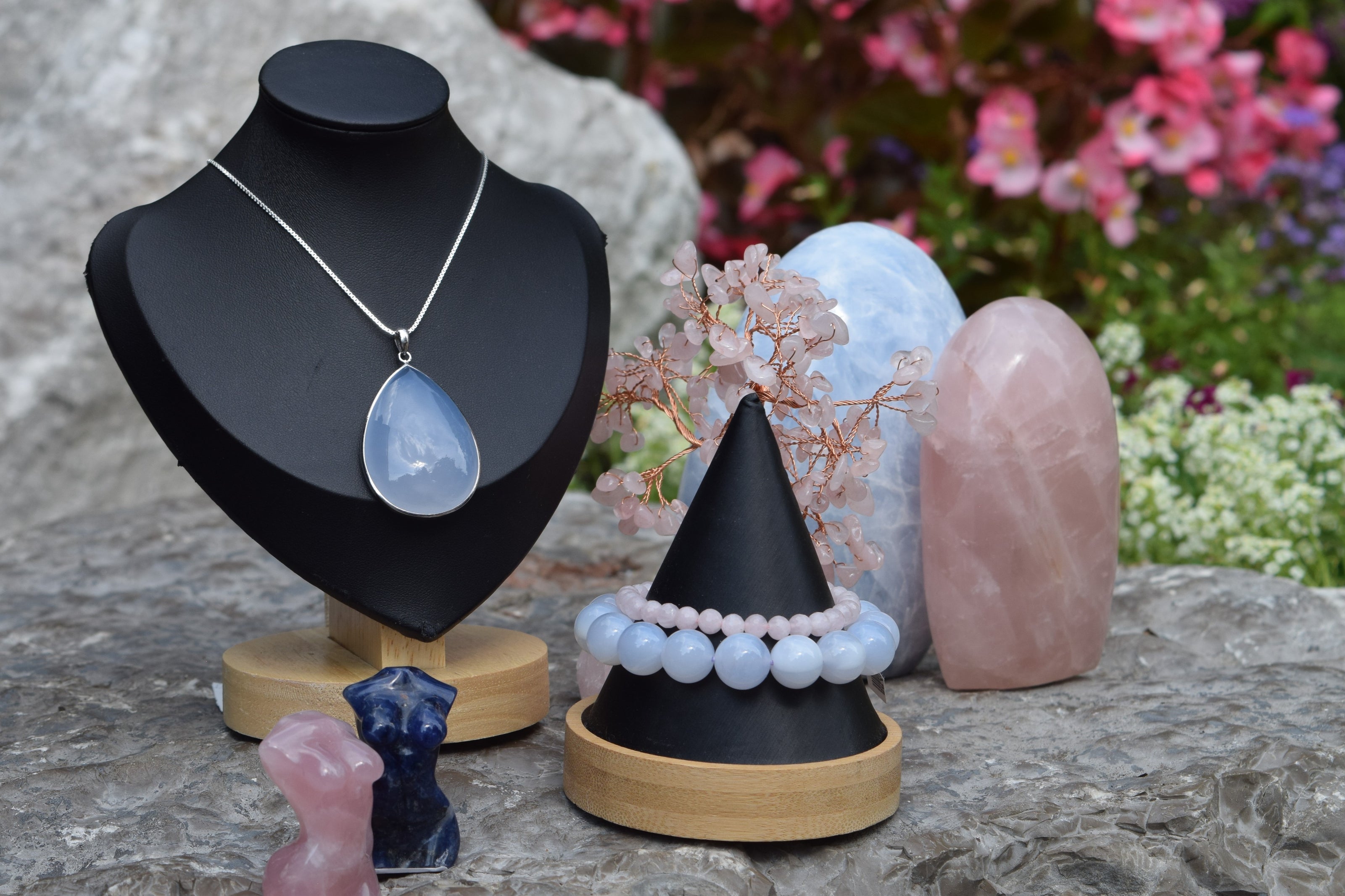 Outdoor display featuring crystal jewelry, small crystal miniatures, a crystal wire tree and crystal stones.