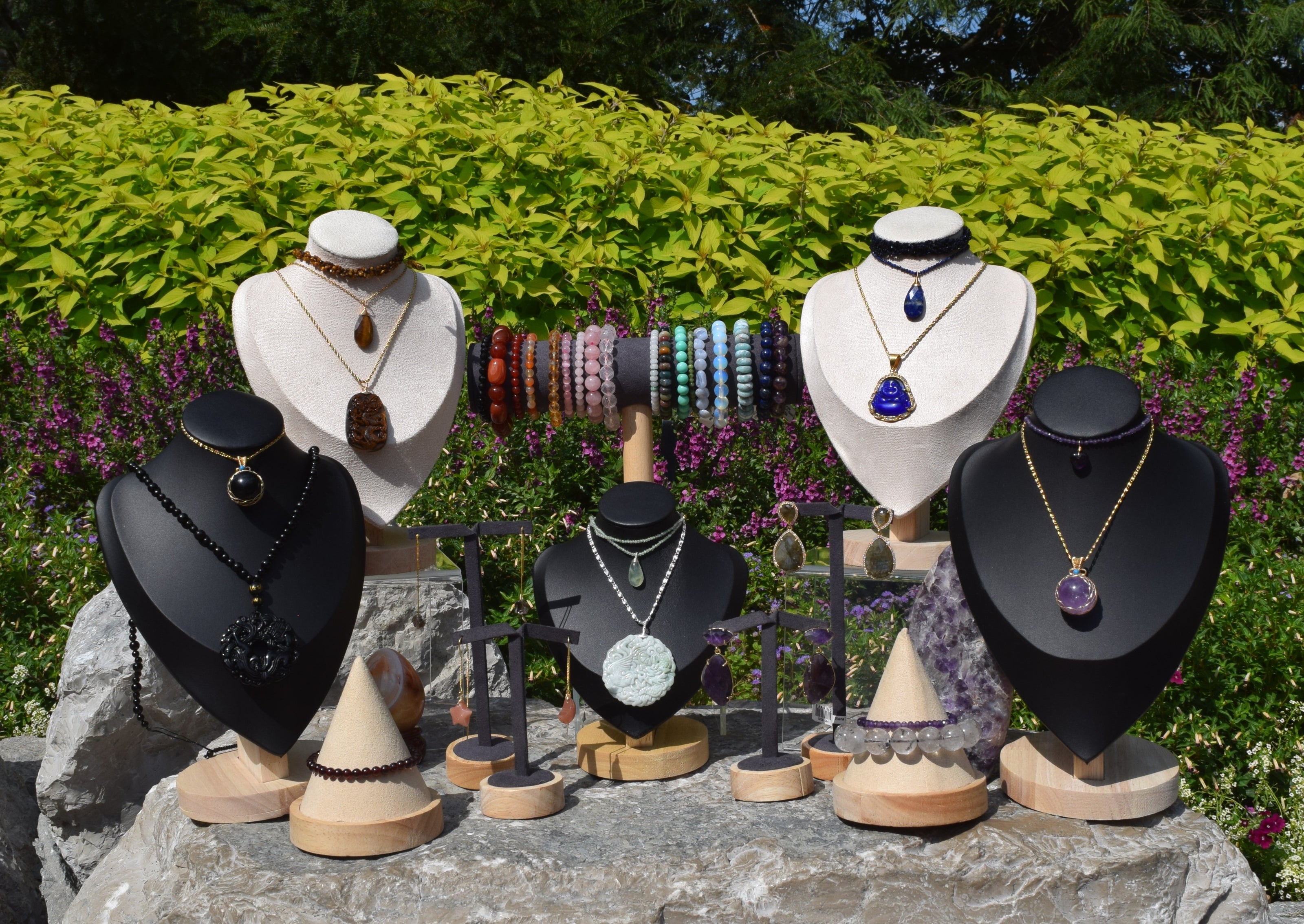 A large outdoor jewelry display, featuring a variety of necklaces, bracelets and earrings